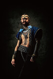 Fototapeta Sawanna - Tattooed bearded man, wearing ethnic clothing and jewelry
