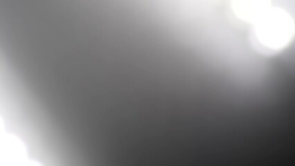 Wall Mural - Black White Shimmering Retro Background. Glowing overflows from light to dark. Abstract retro video background with gradient color change. Loop 4K footage. Natural light leaks and Lens Flare effect.