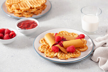 Wall Mural - waffles with Norwegian brunost traditional brown cheese and raspberry jam