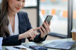 © amnaj - Woman using smartphone working with various applications. Including mobile transactions to send LINE messages and various business information send via social media.