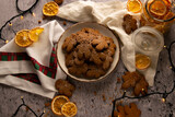 Fototapeta Niebo - Flat lay photography, Christmas gingerbread cookies sprinkled with powdered sugar with dried oranges laying around	