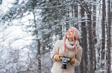 Trendy and stylish. woman hold photo camera. make photo shot of snowy winter nature. cold and beautiful weather. happy hiker girl retro camera. professional photographer winter landscape