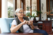 Cheerful senior woman using mobile phone . Elderly lady enjoying freedom and retirement