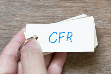 Sticker - Hand hold flash card with handwriting in word CFR (abbreviation of Cost and freight) on wood background