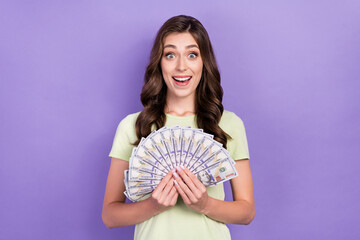 Sticker - Photo of rich business owner company young woman wear white t-shirt hold much money excited big sales profit isolated on purple color background