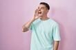 © Krakenimages.com - Handsome hispanic man standing over pink background shouting and screaming loud to side with hand on mouth. communication concept.