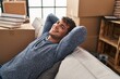 © Krakenimages.com - Young hispanic man relaxed with hands on head sitting on sofa at new home