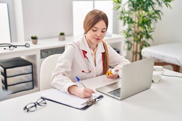 Canvas Print - Young blonde woman wearing doctor uniform prescribe pills treatment at clinic