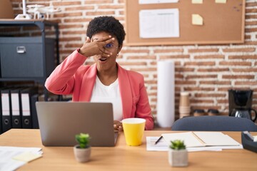 Sticker - Young african american woman working at the office wearing glasses peeking in shock covering face and eyes with hand, looking through fingers afraid