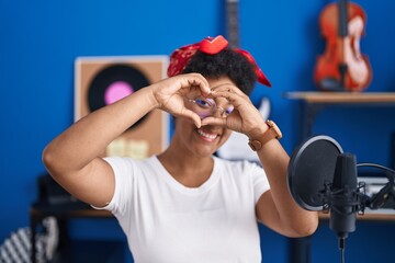 Poster - African american woman musician doing heart gesture with hands at music studio