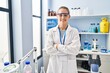 © Krakenimages.com - Young blonde woman wearing scientist uniform standing with arms crossed gesture at laboratory