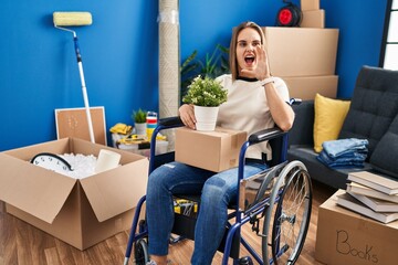 Poster - Young woman sitting on wheelchair moving to a new home shouting and screaming loud to side with hand on mouth. communication concept.