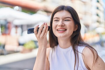 Sticker - Young caucasian woman smiling confident listening audio message by the smartphone at street