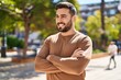 © Krakenimages.com - Young hispanic man smiling confident standing with arms crossed gesture at park