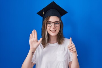 Sticker - Blonde caucasian woman wearing graduation cap showing and pointing up with fingers number six while smiling confident and happy.