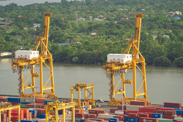 Wall Mural - Aerial view of container cargo ship in the export and import business and logistics international goods in urban city. Shipping to the harbour by crane in Bangkok harbour, Thailand.