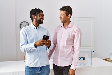 Canvas Print - Two men smiling confident using smartphone at electoral college