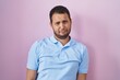 © Krakenimages.com - Hispanic man standing over pink background depressed and worry for distress, crying angry and afraid. sad expression.