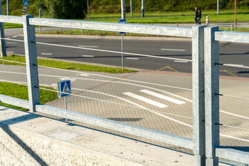 Modern metal fence made of metal profiles and cables. Connection and fastening of iron cables with a steel turnbuckles. Metal fastening of two steel rope. Fencing around the perimeter of the roof