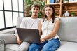 © Krakenimages.com - Man and woman couple smiling confident using laptop at home