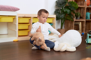 Sticker - Adorable toddler playing with dolls sitting on floor at home