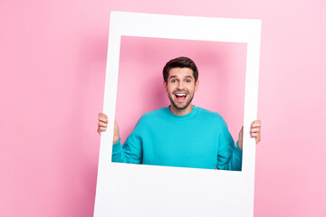 Canvas Print - Photo portrait of attractive young guy excited hold instant photo frame polaroid wear trendy blue outfit isolated on pink color background