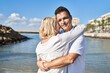 © Krakenimages.com - Middle age man and woman couple hugging each other standing at seaside
