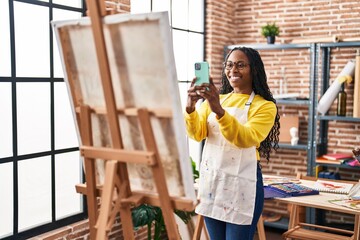 Wall Mural - African american woman artist make picture by the smartphone to draw at art studio