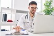 © Krakenimages.com - Young hispanic man doctor smiling confident using laptop at clinic