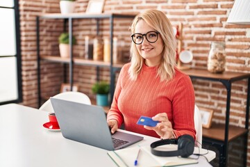 Canvas Print - Young blonde woman smiling confident using laptop and credit card at home