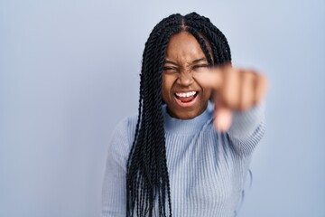 Poster - African american woman standing over blue background pointing displeased and frustrated to the camera, angry and furious with you