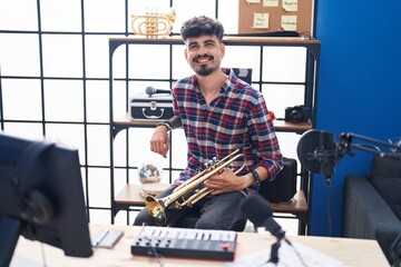 Sticker - Young hispanic man musician holding trumpet at music studio