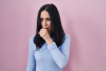 Canvas Print - Hispanic woman standing over pink background feeling unwell and coughing as symptom for cold or bronchitis. health care concept.