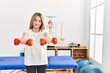 © Krakenimages.com - Young chinese woman doing rehab using dumbbells at clinic