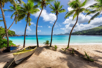 Wall Mural - Paradise beach. Sunny tropical beach and turquoise sea with palm trees and boats in the sand. Summer vacation and tropical beach concept.