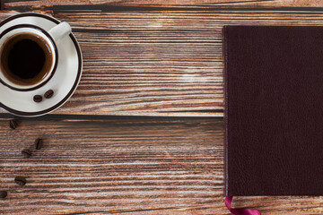 Wall Mural - Holy Bible book and a cup of coffee on wooden background with copy space. Top table view.