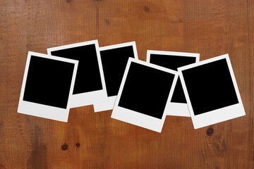 Canvas Print - Set of blank photo frames on brown table background