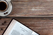 Open holy bible book Luke gospel with coffee cup on wooden background. Copy space. Top table view. Studying Christian Scriptures, biblical concept.	
