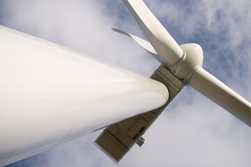 Looking Up On Tall Wind Turbine Tower Against Summer Sky. low angle