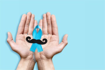 Canvas Print - Prostate cancer concept. Hands with blue ribbon and mustache