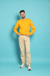 © New Africa - Full length portrait of handsome man on light blue background