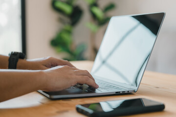 Aufkleber - working on a laptop computer. male hands typing on a laptop keyboard at the office.