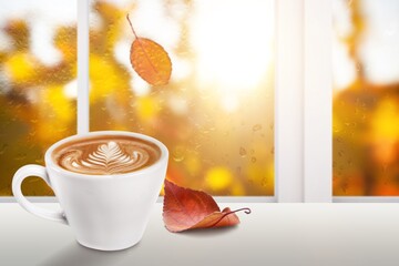 Sticker - Coffee cup on windowsill on autumn background