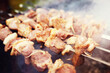© alexkich - Selective focus. Cooking barbecue on the mangal in nature. Grilled tasty meet cooking on the party. Traditional Russian shashlik on a barbecue skewer on sunny forest.