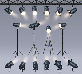 Realistic spotlights. Lamp on tripod stand, photo studio or stage light equipment. Spotlight with light beam glow effect vector set