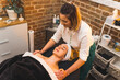 © PoppyPix - Focused female beautician doing a massage on her relaxed blonde client's face. High quality photo