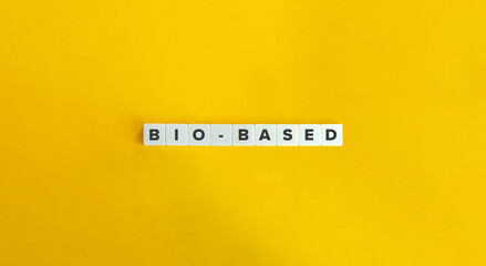 bio-based phrase on letter tiles on yellow background. minimal aesthetics.