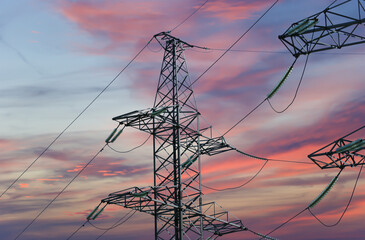 Electricity pylon (high voltage power line) against the background of a romantic evening sky