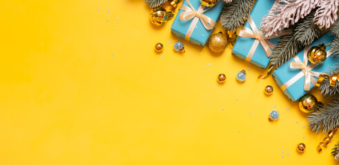 Wall Mural - Christmas background with pine tree, gifts and festive decorations top view. Christmas flat lay. Copy space