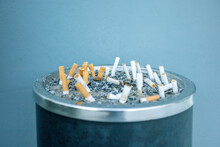 Cigarette Butts In The Urn. Cigarette Disposal Urn Full Of Cigarettes.